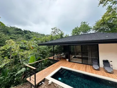 a house with a deck and a swimming pool at CASA TUCAN , New House with Pool in Paradise, jungle view in Santa Teresa Beach