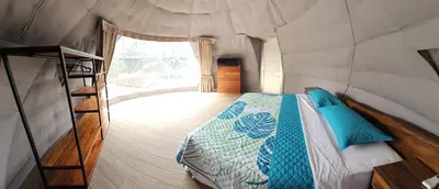 a bedroom in a tent with a bed and a window at Moonlight 02 in Fortuna