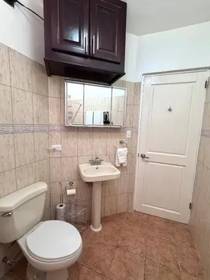 a bathroom with a toilet and a sink at Coco Daydreamin with a Rooftop Terrace in Coco