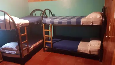 two bunk beds are in a room with at Hostel Monteverde Backpackers in Monteverde Costa Rica