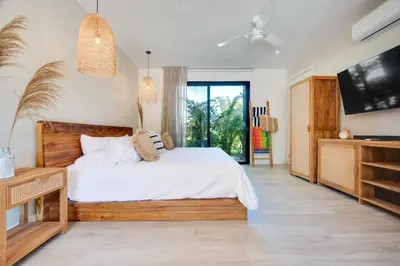 a bedroom with a large bed and a tv at The Bungalows #1 - Boutique Hotel in Flamingo Beach - Ground Level Studio in Playa Flamingo