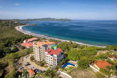 an aerial view of a resort on the beach at Stunning Condo with Panoramic Beach, Ocean, and Mountain Views in Playa Flamingo in Playa Flamingo