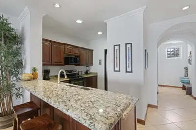a kitchen with a granite counter top and a kitchen island at Stunning Condo with Panoramic Beach, Ocean, and Mountain Views in Playa Flamingo in Playa Flamingo