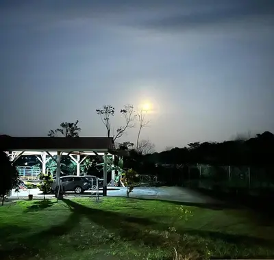 a parking lot with a car parked under a light at Volcano Refuge House in Fortuna