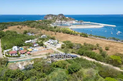 an aerial view of an island with boats in the water at The Bungalows #6 - Boutique Hotel in Flamingo Beach - Top Level Studio in Playa Flamingo