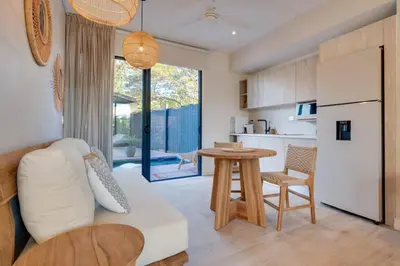 a living room with a white couch and a table at The Bungalows #7 - Boutique Hotel in Flamingo Beach - Ground Level Studio in Playa Flamingo