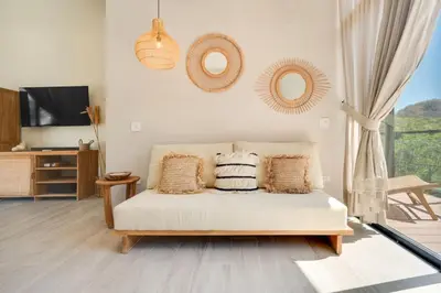 a living room with a couch and a tv at The Bungalows #7 - Boutique Hotel in Flamingo Beach - Ground Level Studio in Playa Flamingo