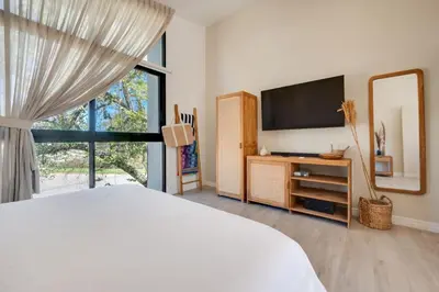 a bedroom with a bed and a tv and a window at The Bungalows #8 - Boutique Hotel in Flamingo Beach - Top Level Studio in Playa Flamingo
