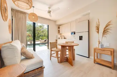 a kitchen and living room with a couch and a table at The Bungalows #8 - Boutique Hotel in Flamingo Beach - Top Level Studio in Playa Flamingo