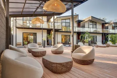 a patio with chairs and tables and a building at The Bungalows #8 - Boutique Hotel in Flamingo Beach - Top Level Studio in Playa Flamingo
