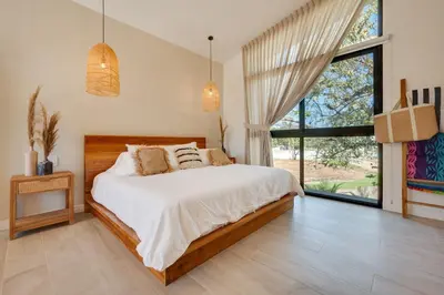 a bedroom with a bed and a large window at The Bungalows #8 - Boutique Hotel in Flamingo Beach - Top Level Studio in Playa Flamingo