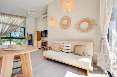 a living room with a couch and a table at The Bungalows #9 - Boutique Hotel in Flamingo Beach - Ground Level Studio in Playa Flamingo
