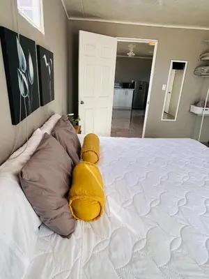 a large bed with a yellow teddy bear on it at Apartamento Einoah in Puerto Limón