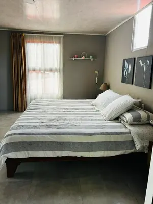 a bedroom with a large bed in a room at Apartamento Einoah in Puerto Limón