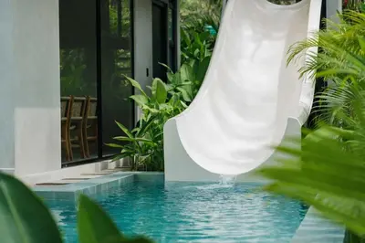 a white water slide in a swimming pool at Manuel Antonio Tree House Villas - 4 Bedrooms in Quepos