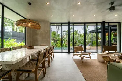 a dining room with a large table and chairs at Manuel Antonio Tree House Villas - 4 Bedrooms in Quepos