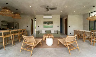 a living room with a couch and a table and chairs at Manuel Antonio Tree House Villas - 4 Bedrooms in Quepos