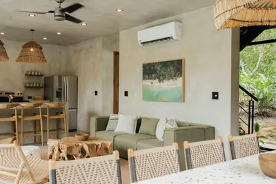 a living room with a couch and a table at Manuel Antonio Tree House Villas - 4 Bedrooms in Quepos