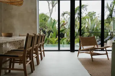 a room with chairs and a counter with windows at Manuel Antonio Tree House Villas - 4 Bedrooms in Quepos