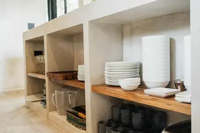 a cupboard with plates and dishes on it at Manuel Antonio Tree House Villas - 4 Bedrooms in Quepos