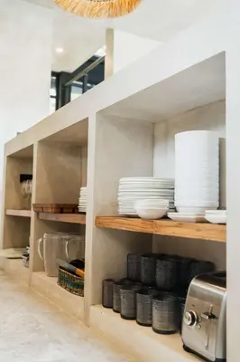 a kitchen with white plates and dishes on shelves at Manuel Antonio Tree House Villas - 4 Bedrooms in Quepos
