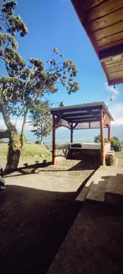 a picnic shelter with a view of the ocean at Hospedaje Jac Cabaña de Campo in Cartago
