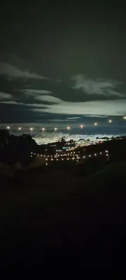 a view of a city at night with lights at Hospedaje Jac Cabaña de Campo in Cartago