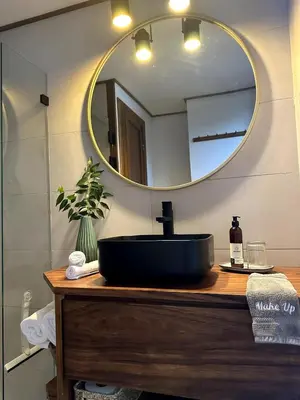 a bathroom with a black sink and a mirror at NATURAVE HOME - Tiny house with mountain view in Monteverde Costa Rica