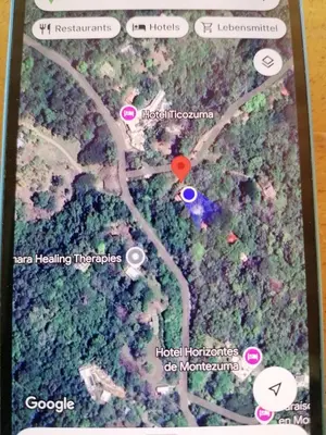a screenshot of a cell phone with a map at Cabinas casa las flores in Montezuma