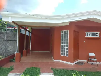 a red house with a white roof at Casa Victoria in Orosí