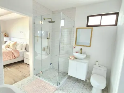 a bathroom with a shower and a toilet and a sink at Beautiful and cozy home in Alajuela City