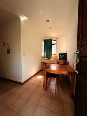 a dining room with a wooden table and a window at Drift Away Lodge CR in Santa Cruz