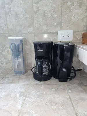 two coffee makers sitting on a counter next to a blender at Casa Rosa - Beach Front in Tortuguero