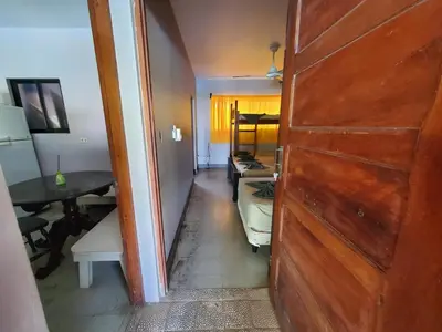 a door to a room with a table and a desk at Casa Canadiense in Chacarita