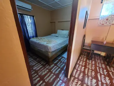 a small bedroom with a bed and a desk at Casa Canadiense in Chacarita