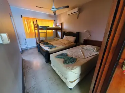 two twin beds in a room with a window at Casa Canadiense in Chacarita