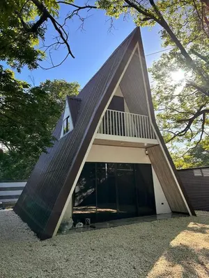 a house with a triangular roof with a garage at Cabaña del Mar in Garita