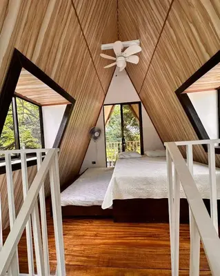 a bedroom with a ceiling fan and a bed in a room at Cabaña del Mar in Garita