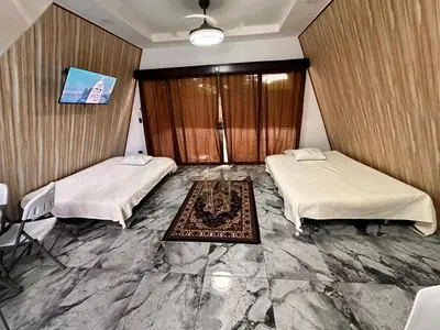 a room with two beds and a table at Cabaña del Mar in Garita