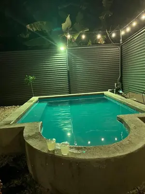 a swimming pool at night with lights around it at Cabaña del Mar in Garita