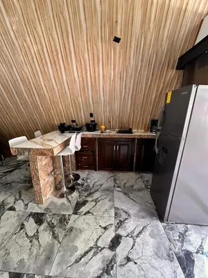 a kitchen with a counter and a refrigerator in it at Cabaña del Mar in Garita