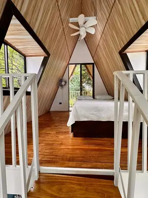 a bedroom with a ceiling fan and a bed at Cabaña del Mar in Garita