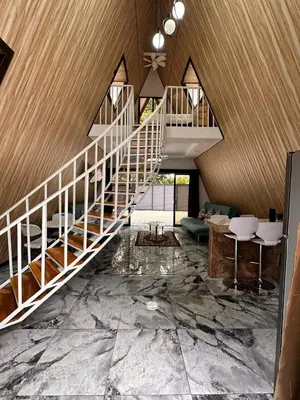 a living room with a staircase and marble floors at Cabaña del Mar in Garita