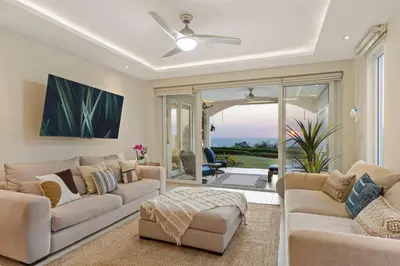 a living room with two couches and a ceiling fan at Infinity Pools & Sunsets Over Tamarindo Bay in Tamarindo