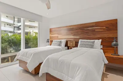 a bedroom with two beds and a large window at Infinity Pools & Sunsets Over Tamarindo Bay in Tamarindo
