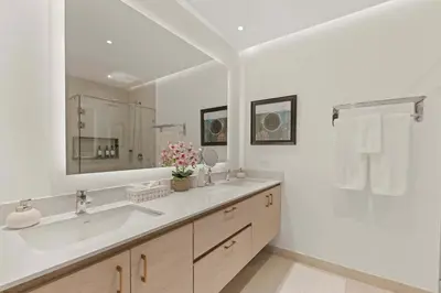 a bathroom with a sink and a large mirror at Infinity Pools & Sunsets Over Tamarindo Bay in Tamarindo