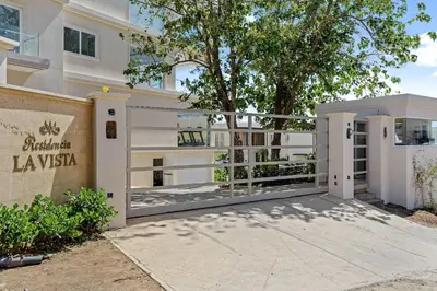 a large white building with a sign that reads la vista at Infinity Pools & Sunsets Over Tamarindo Bay in Tamarindo