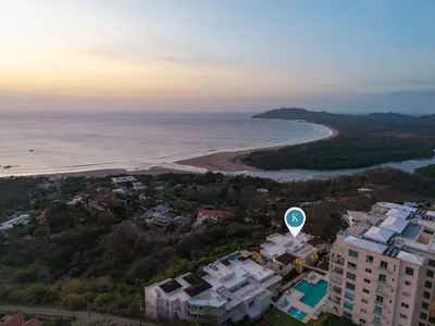 an aerial view of a beach with buildings and the ocean at Infinity Pools & Sunsets Over Tamarindo Bay in Tamarindo