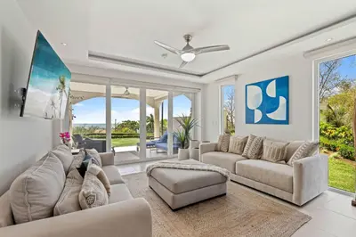 a living room with couches and a ceiling fan at Infinity Pools & Sunsets Over Tamarindo Bay in Tamarindo