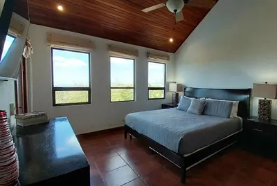 a bedroom with a bed and some windows at Villa Estrellas - Stunning Ocean-Views, Potrero, spacious 4 BR Villa in Potrero